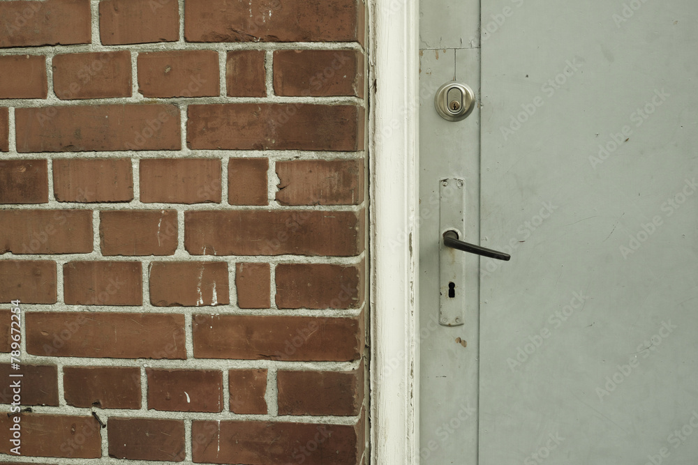 Brick wall, door and building in urban area for design, texture and architecture for construction. Concrete, pattern and vintage structure for development, exterior and maintenance in old town.