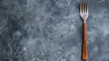 A fork on a gray background with the word 