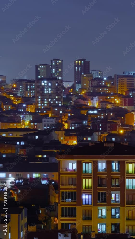 Timelapse, vertical video: moving clouds in the dark sky over typical turkish residential buildings with warm illumination and blinking windows in Istanbul, Turkey at night: time lapse concept Timelapse, vertical video: moving clouds in the dark sky over typical turkish residential buildings with warm illumination and blinking windows in Istanbul, Turkey at night: time lapse concept
