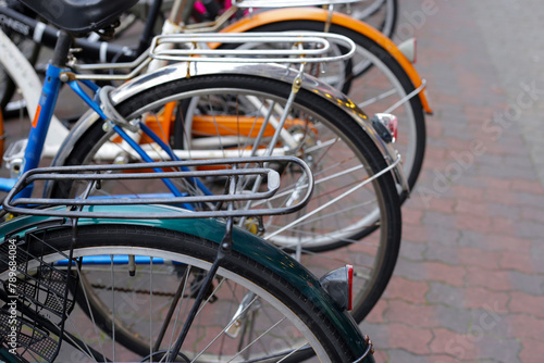 A group of bicycles lined up in a row on the sidewalk.