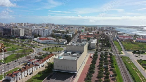 Traditional modern Portuguese oceanfront town of Faro overlooking the theater, filmed by drone. Ria formosa in the background.