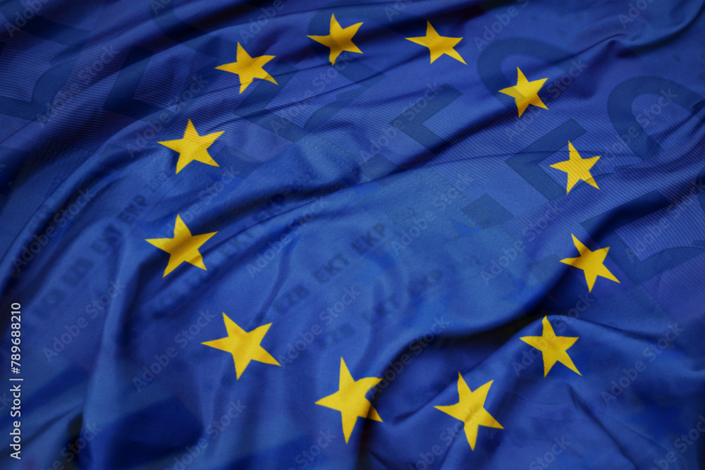 waving colorful national flag of european union on a euro money banknotes background. finance concept. waving colorful national flag of european union on a euro money banknotes background. finance concept.