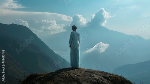 A midwife stands on a mountaintop a symbol of her unwavering strength and courage in the face of the challenging and emotionally demanding duties she fulfills as she supports women .