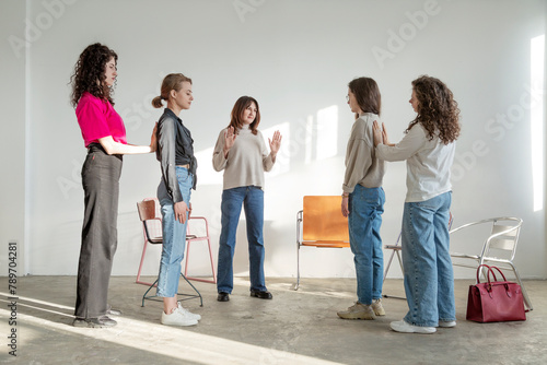 Group of young women rehearsing while standing together in room photo
