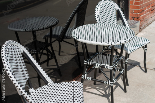bistro table and chairs set outside on a sidewalk photo