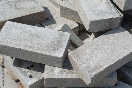rectangular gray concrete blocks in a rough pile outside