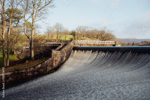 Fast flowing water on a reservoir weir photo