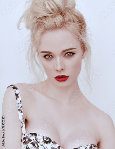 Potrait of young attractive woman with long and shiny blonde hair on white, red lips. Friendly natural casual portrait.