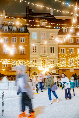 Outdoor Ice rink with many tourists in the old European city photo