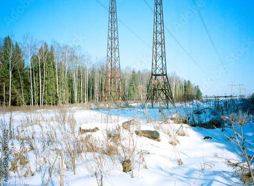 Analog snowy landscape with electric towers 