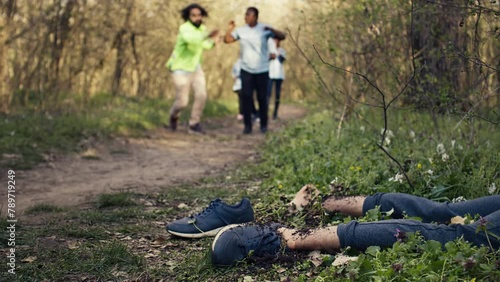 Rescuers group finding murdered barefoot victim in the forest, scared people calling the police. Mysterious horror manslaughter in the woods, civilians found a dead body, grim murder. Camera B.