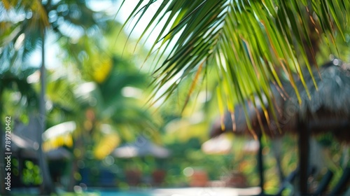 In this defocused background image vibrant green palm trees and inviting cabanas blur into the distance creating a dreamy and relaxing atmosphere perfect for a leisurely getaway. . photo