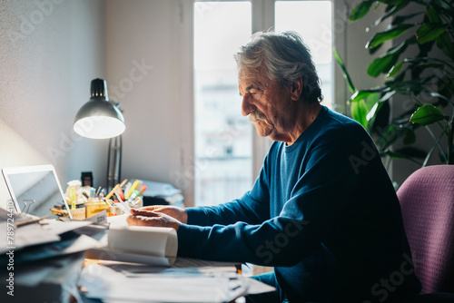 Man working in cluttered desk photo