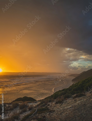 Golden sunset seascape with approaching thunderstorm clouds 