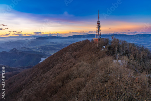 The top of the Boč mountain after the sunset on a beautiful winter afternoon, Slovenia photo