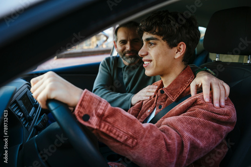 Father teaching his son to drive photo