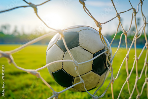 A soccer ball in a goal net