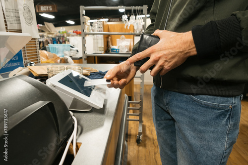Person Paying in Store by Tapping a Contactless Credit Card