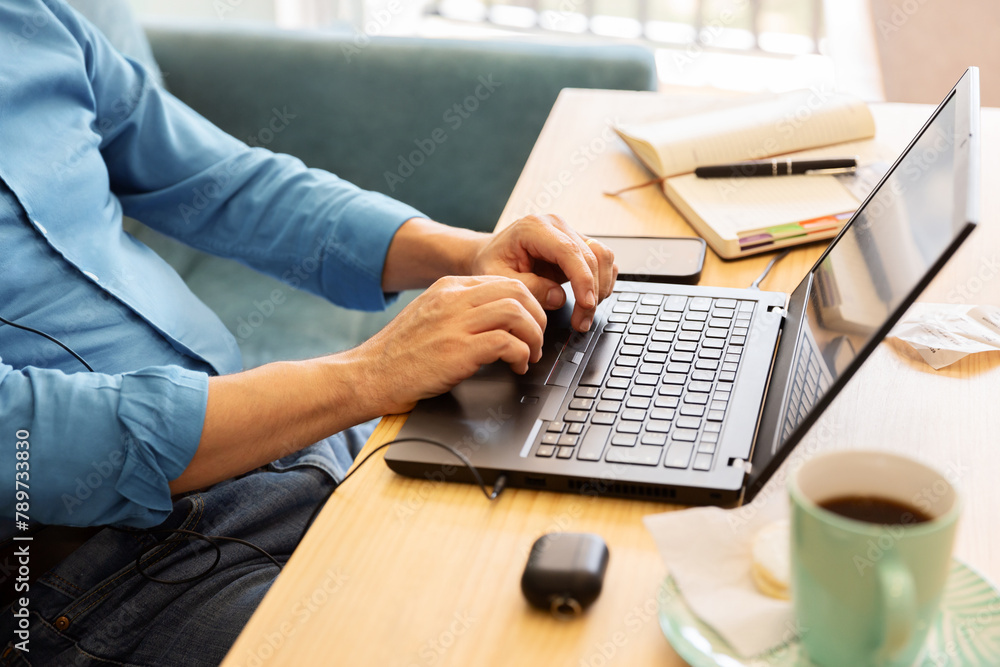 © Ángela Rober/Stocksy - Unrecognizable man works on his laptop from his home office © Ángela Rober/Stocksy - Unrecognizable man works on his laptop from his home office