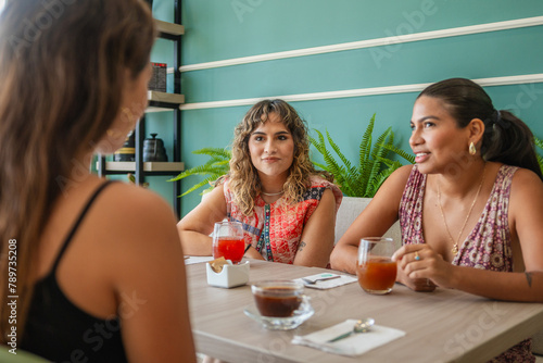 Friends Gossiping in a Restaurant  photo