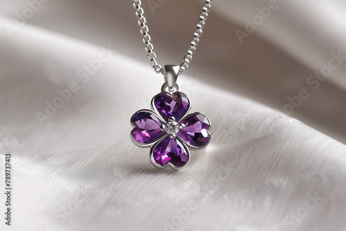 Amethyst clover pendant on a silver chain draped over silky fabric, capturing luxury, elegance, and sophistication in jewelry design