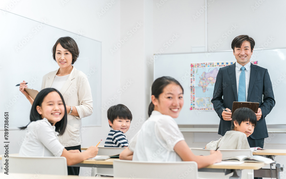 塾・学童・学校の教室で小学生に勉強を教える男女の教師・学童指導員・塾講師
塾・学童・学校の教室で小学生に勉強を教える男女の教師・学童指導員・塾講師