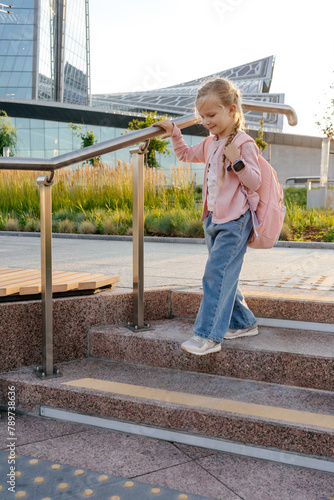 Elementary school student stepping down stairs photo