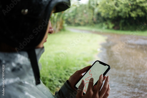 Motorcyclist Using Smartphone Navigation in Rain photo