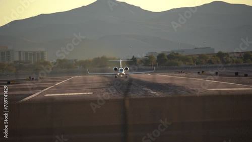 Airplane is speeding up and taking off from Harry Reid International Airport in Las Vegas at evening during sunset in beautiful place in Nevada
