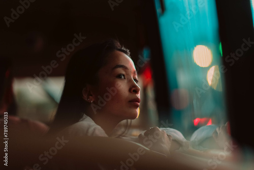 young girl looking out the bus window