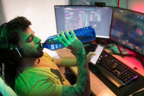 Gamer drinking water during gaming break  photo
