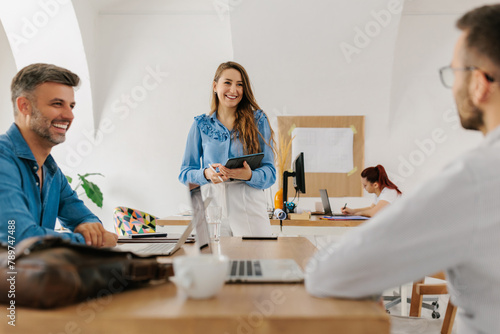 Young female leading a meeting in office  photo