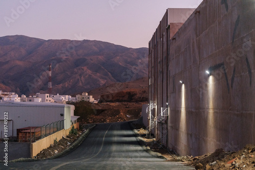 Lonely road in mountainous area with buildings photo