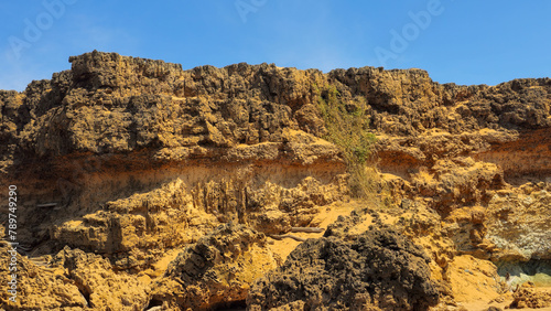 rocas en las playas de pilon de azucar, cerca al cabo de la vela, colombia. son formaciones rocosas al parecer de origen volcanico que llegan casi hasta el mar en este lugar. photo