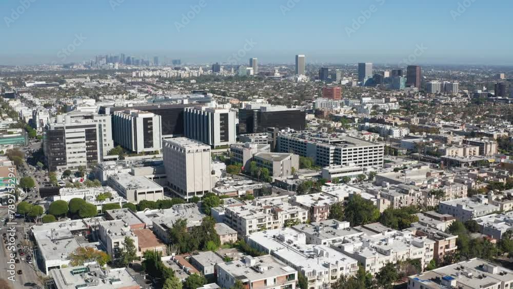 Aerial pullback shot of Beverly Hills shops, homes, apartments, and LA skyline Aerial pullback shot of Beverly Hills shops, homes, apartments, and LA skyline