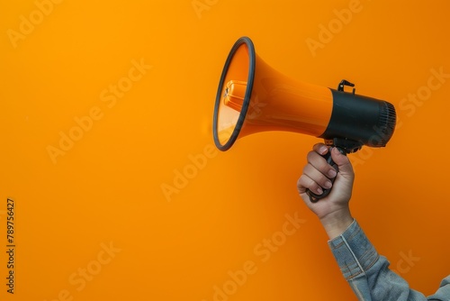 An image depicts a hand holding a megaphone against an orange background, symbolizing marketing and sales concepts with vibrant appeal.