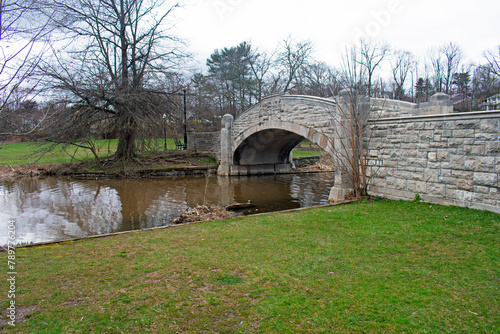 Cute stone bridge over Verona Lake in Verona Park, Verona, New Jersey, on an overcast day in early springtime -02