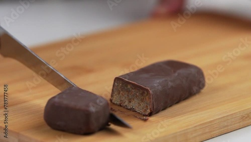 Cutting a candy bar with a knife on the cutting board