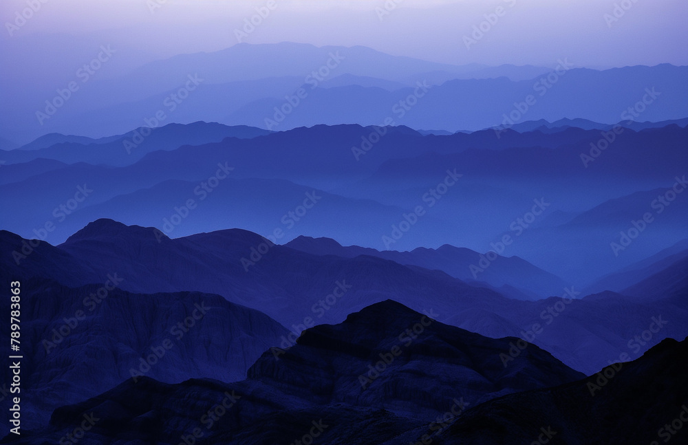Mysterious Blue Twilight Over Layered Mountain Ridges
