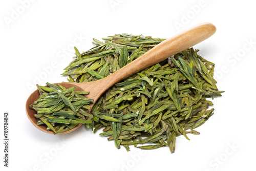 green dried Longjing tea leaves with wooden spoon isolated on white background
