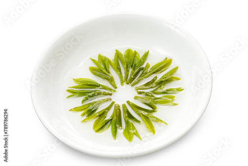 brewed Longjing tea leaves are in a small dish. photo