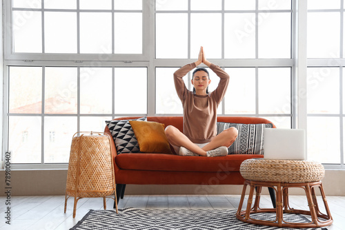 Beautiful woman meditating ...