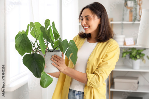 Young woman with plant at home