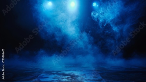 Blue spotlights illuminate the empty stage with smoke