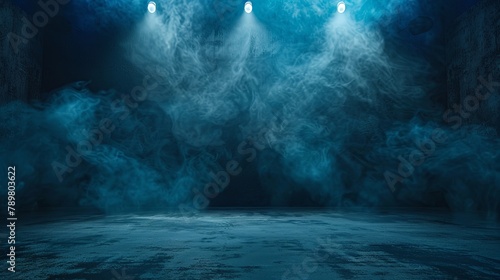 Blue spotlights illuminate the empty stage with smoke.