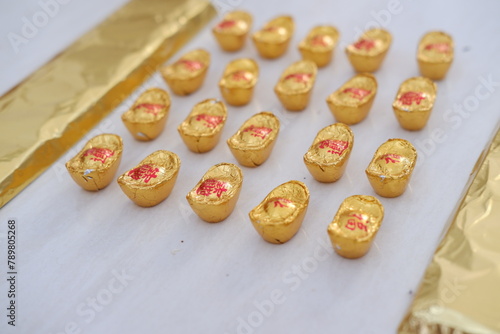 chinese gold chocolates on white background, chinese sweets