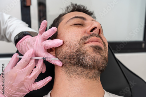 Doctor applying Botox for jawline contouring: cosmetic treatment for male patient's facial definition and skincare, Enhancing jaw with botulinum toxin