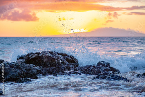 Sunset at Maui, Hawaii.  Waves Crashing Into Volcanic Rocks