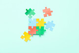 Color puzzle on cyan background. Concept of autistic disorder