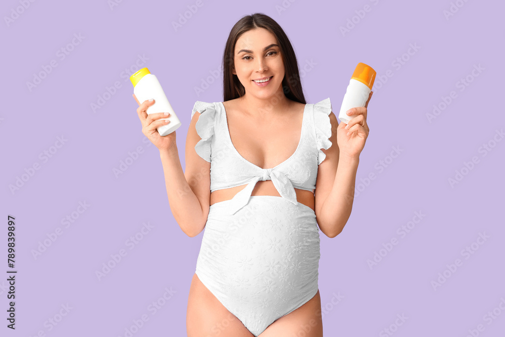 Young pregnant woman holding sunscreens on lilac background. Travel concept Young pregnant woman holding sunscreens on lilac background. Travel concept